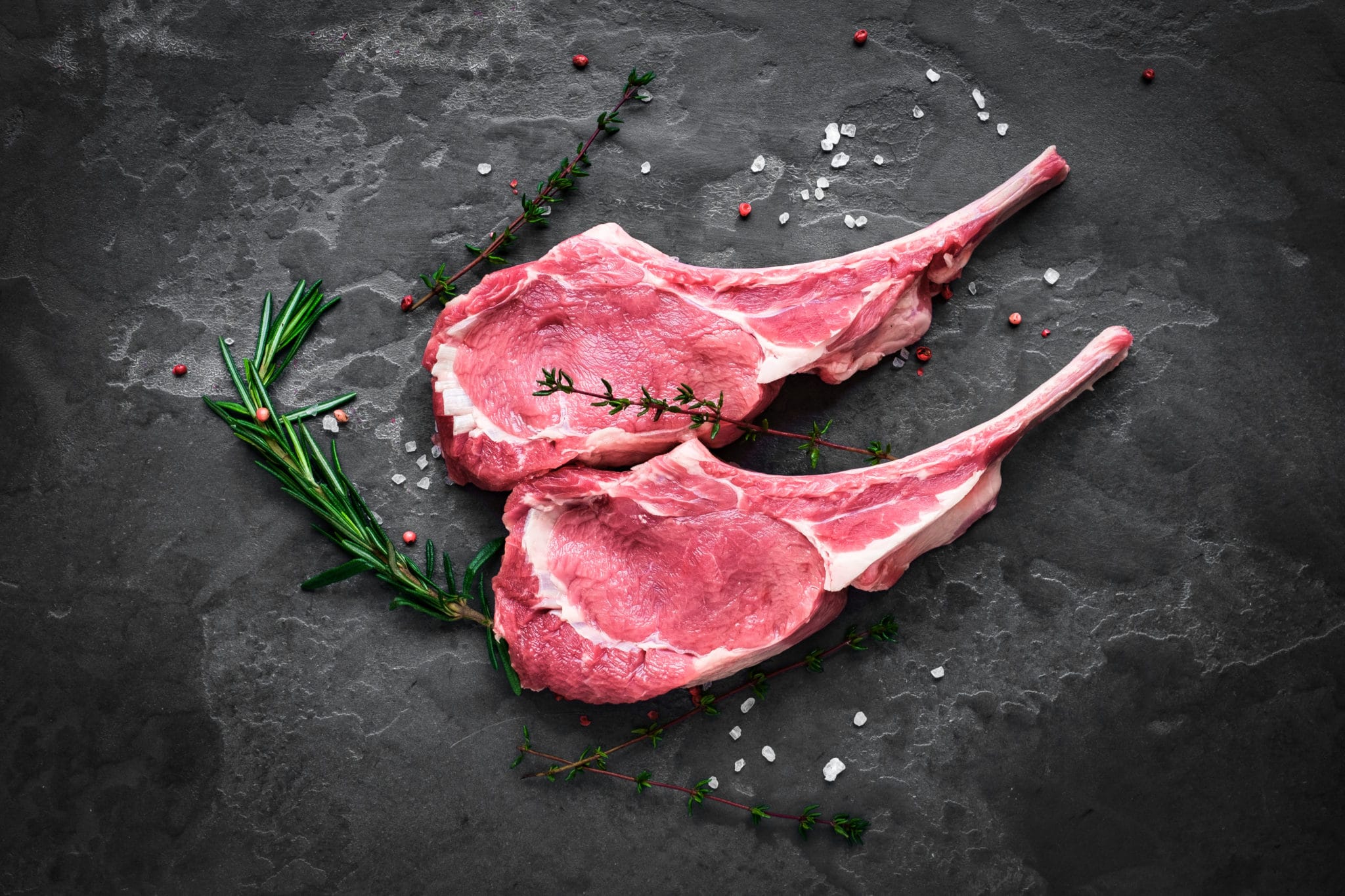 raw veal steak on the bone on the dark stone - Tony's Meats & Market